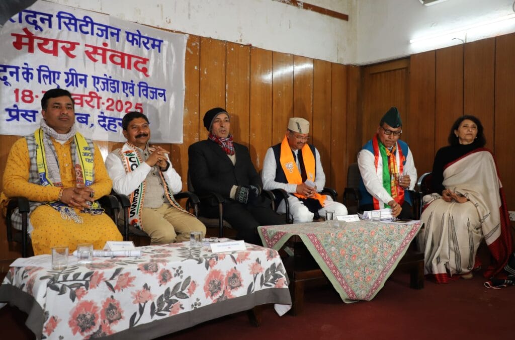 Mayoral candidates seated on dais during dialogue with citizens in Dehradun