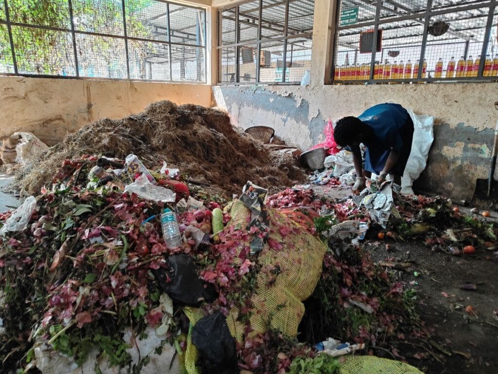 Unsegregated waste collected from nearby vegetable markets dumped for segregation at the micro composting centre