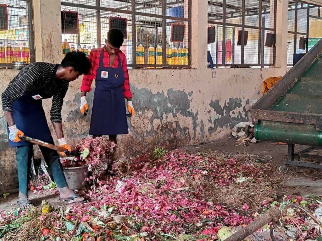 staff at the micro composting centre mixing waste