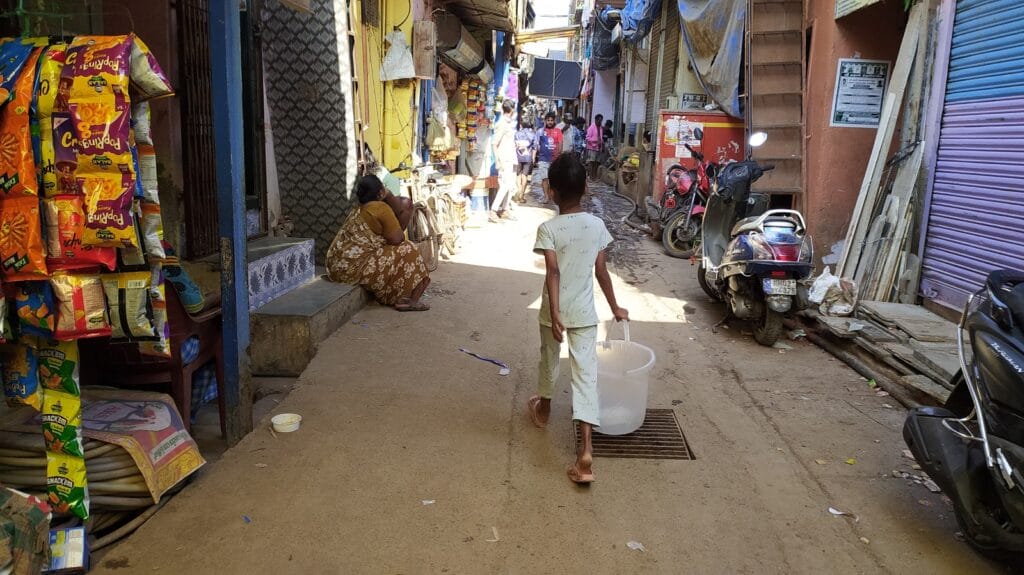 child carrying water in the hot sun in Mumbai