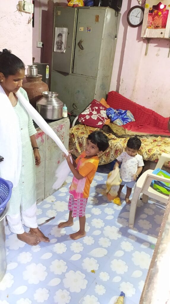 Sheetal with her two kids inside their home. :  