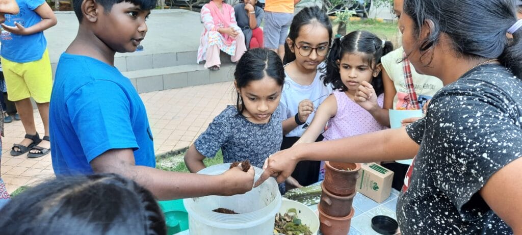 kids learn about waste management and composting in Thalambur