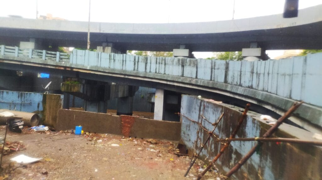 A river retaining wall which has been broken and patched up