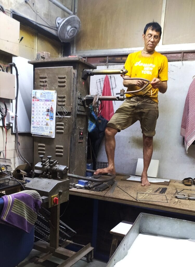 Rohit Gandhi standing atop a raised platform next to his equipment