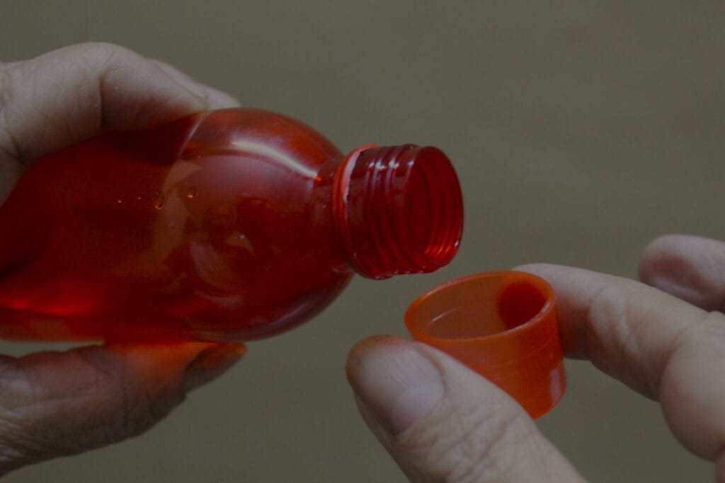 pouring cough syrup