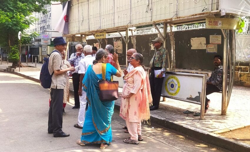 senior citizens at a bus stop in Mumbai. 