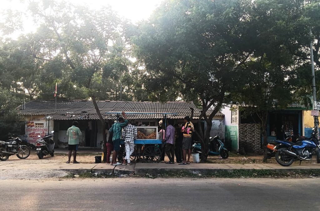 Workers in front of a food cart