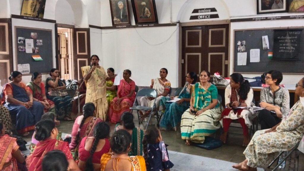 Saundarya shareholding members sitting around their President as the latter speaks during the cooperative's annual general meeting.