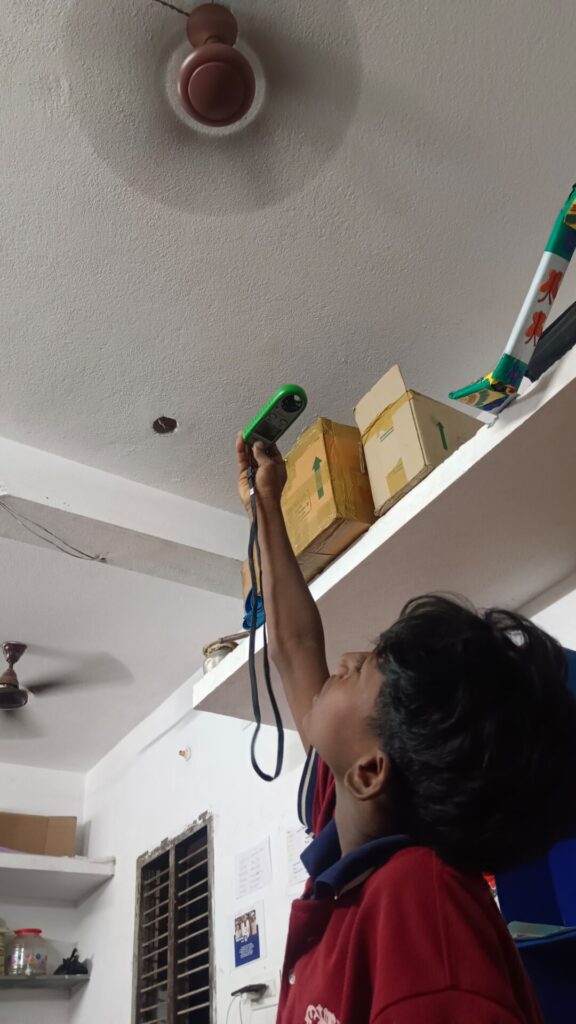 child recording indoor temperatures.